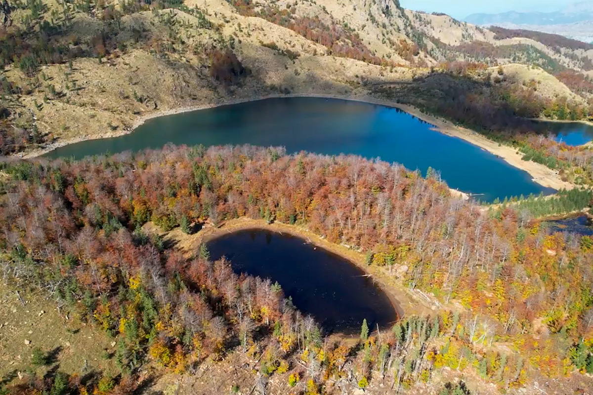 Glacial lakes of Lura surrounded by autumn forest